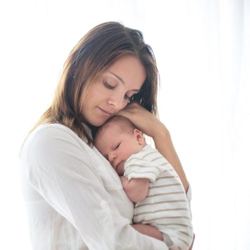 Young-mother-holding-her-newborn-baby-boy-845992464_2125x1416-scaled-1